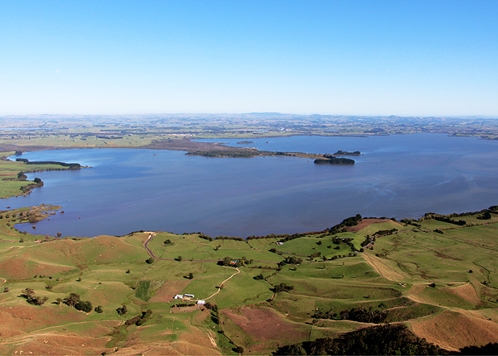 Aerial view across Lake Waikare with surrounding farmland and hills